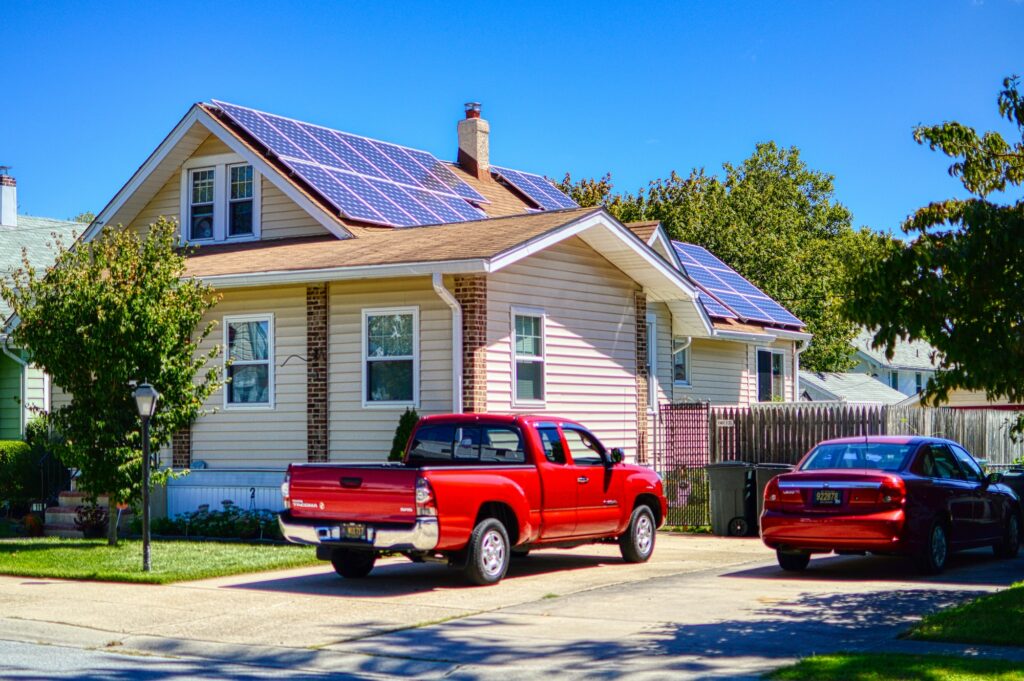 a red pick up truck parked in front of a house